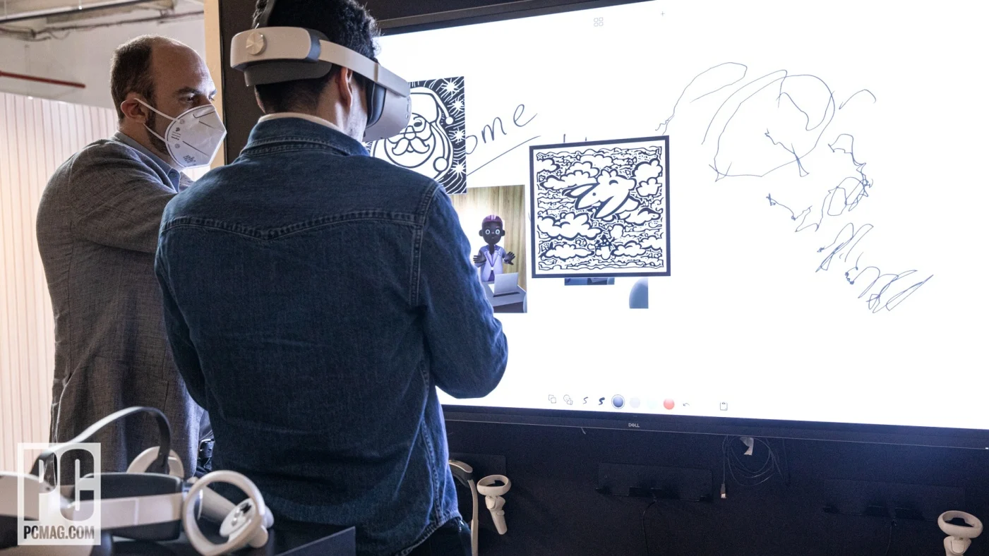 A journalist trying one of the VR demos on the CES 2023 press tour, sketching in headset onto a Dell touchscreen.